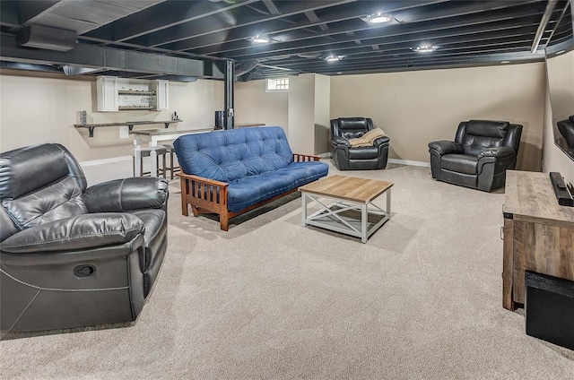 living area with bar area, baseboards, and carpet floors