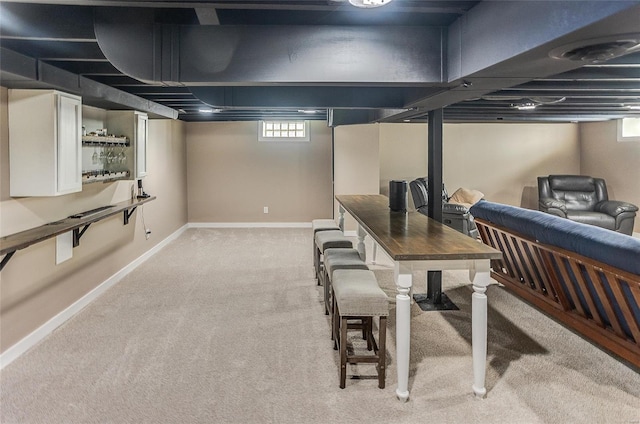 basement with baseboards and light carpet