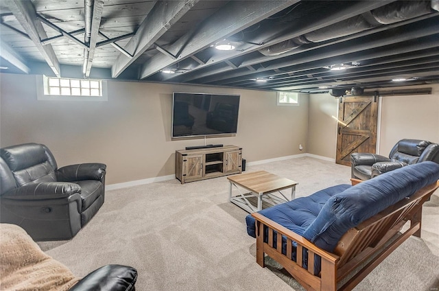 living room featuring baseboards, a barn door, and carpet floors