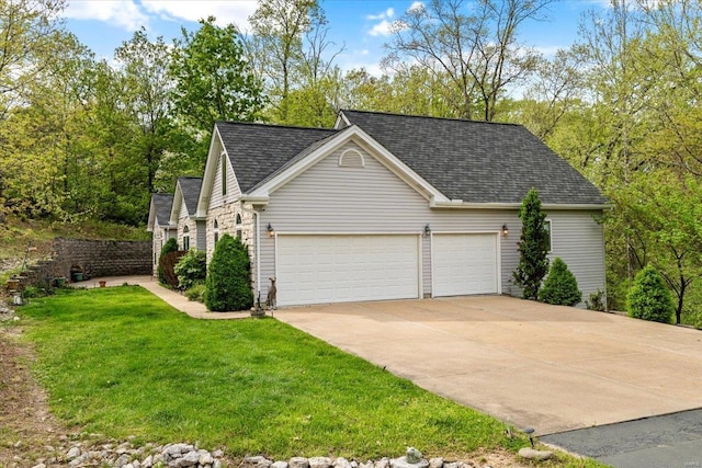 view of home's exterior with concrete driveway, a lawn, a garage, and roof with shingles