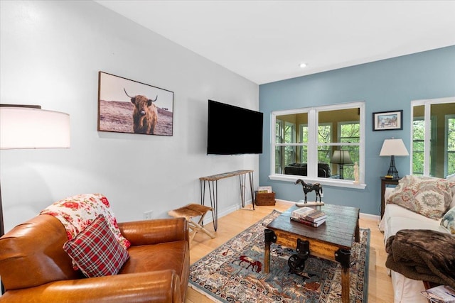 living room featuring wood finished floors, recessed lighting, and baseboards