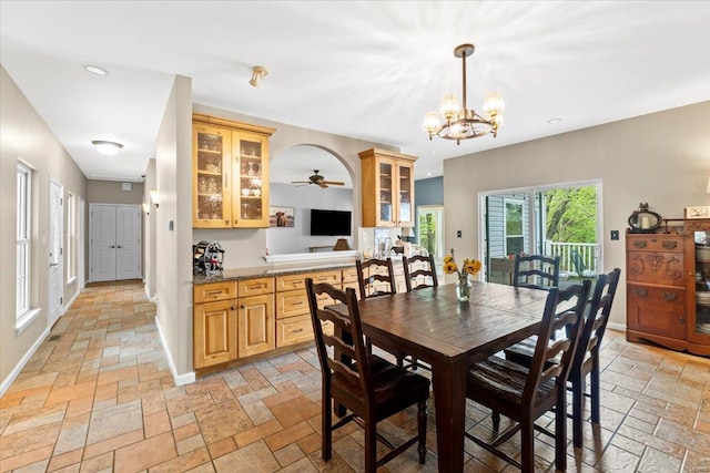 dining room with stone tile flooring, recessed lighting, baseboards, and ceiling fan with notable chandelier