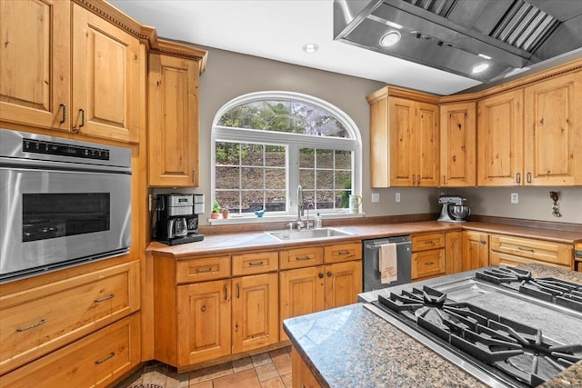 kitchen with exhaust hood, recessed lighting, a sink, stone finish floor, and appliances with stainless steel finishes