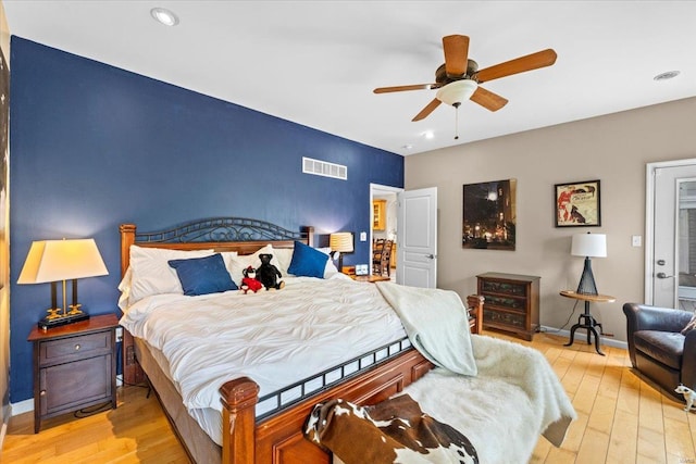 bedroom featuring light wood finished floors, recessed lighting, and visible vents