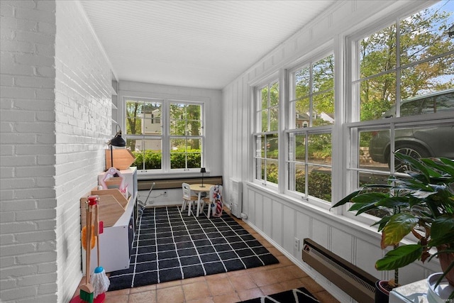 sunroom featuring tile patterned floors and baseboard heating