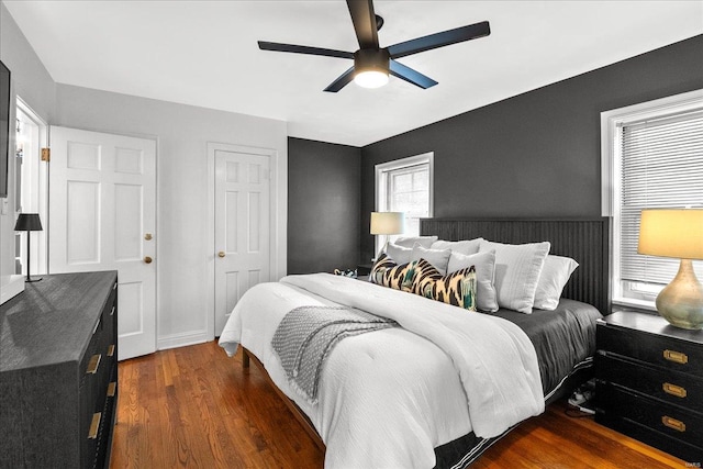 bedroom with ceiling fan and dark wood finished floors