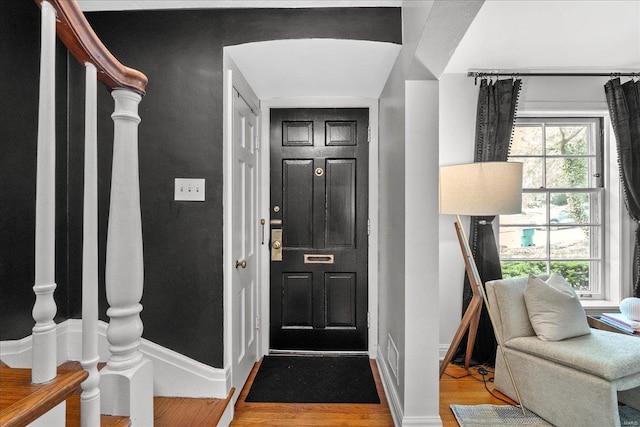 entryway featuring baseboards and light wood-style flooring