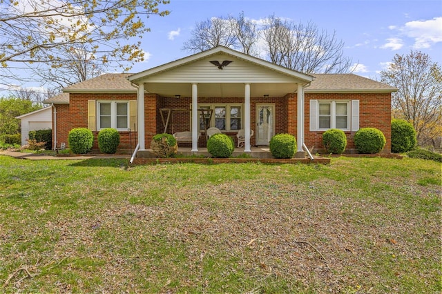 view of front of home featuring brick siding, a front yard, a shingled roof, and a garage