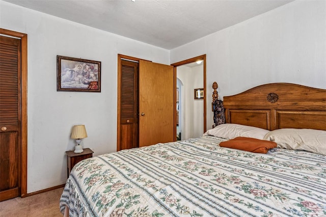 bedroom with light carpet and baseboards