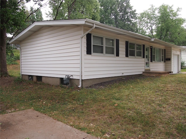 view of home's exterior with a lawn and a garage