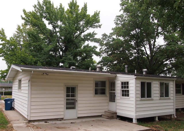 rear view of house with a patio and entry steps