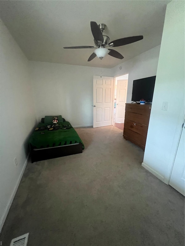bedroom with visible vents, baseboards, ceiling fan, and carpet