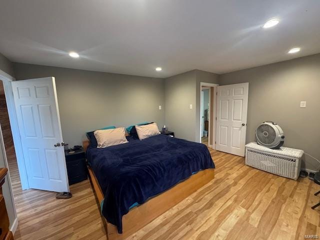 bedroom with recessed lighting and light wood-type flooring