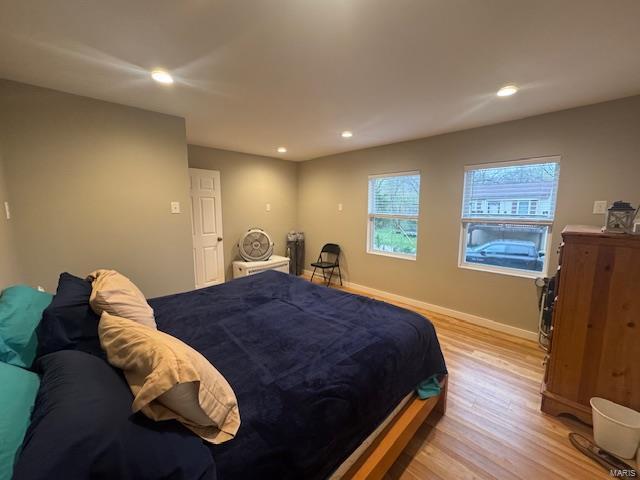 bedroom featuring baseboards, light wood finished floors, and recessed lighting