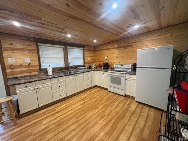 kitchen with white cabinets, wooden ceiling, light wood-type flooring, white appliances, and wooden walls