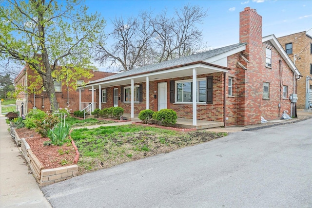 view of front of property featuring a porch and brick siding