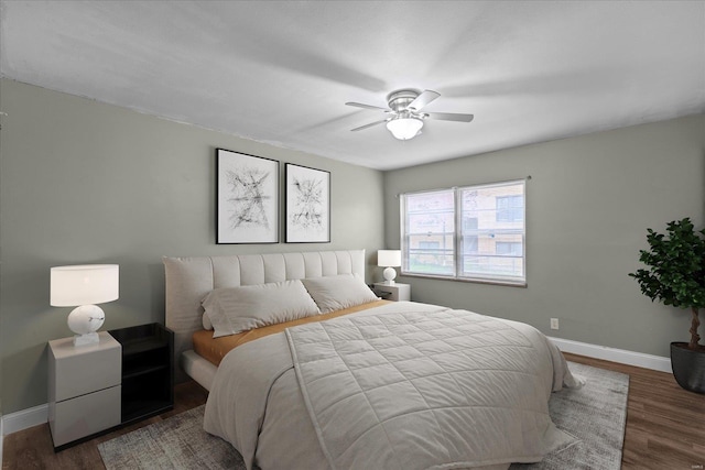 bedroom with wood finished floors, ceiling fan, and baseboards