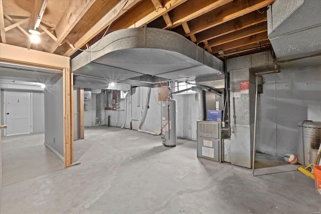 unfinished below grade area featuring gas water heater and heating unit
