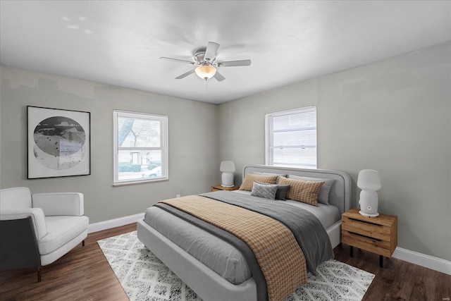 bedroom featuring dark wood-type flooring, baseboards, and a ceiling fan