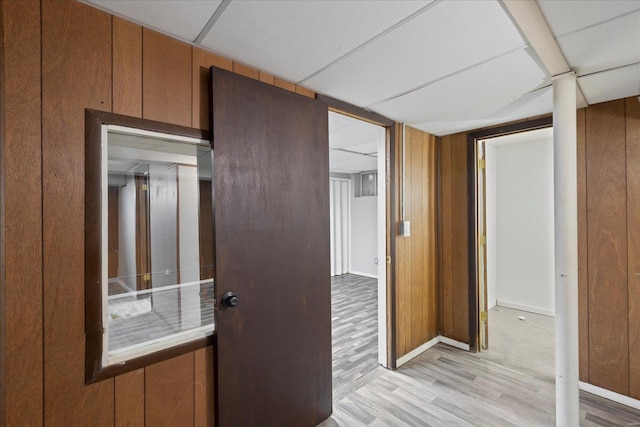 hallway with baseboards and light wood-style floors