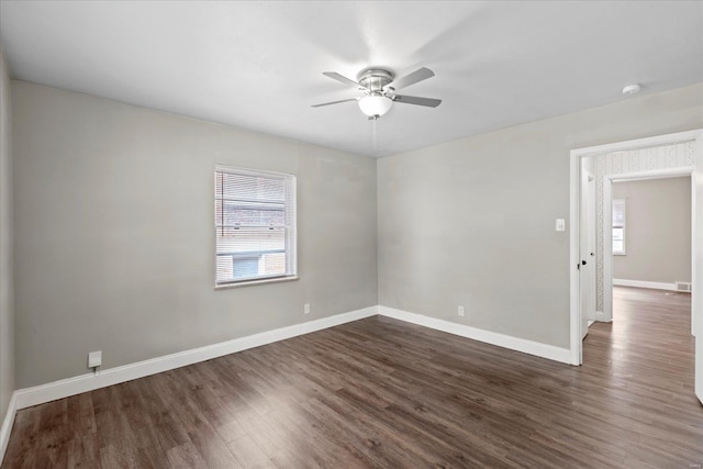 empty room with ceiling fan, dark wood-style floors, and a healthy amount of sunlight