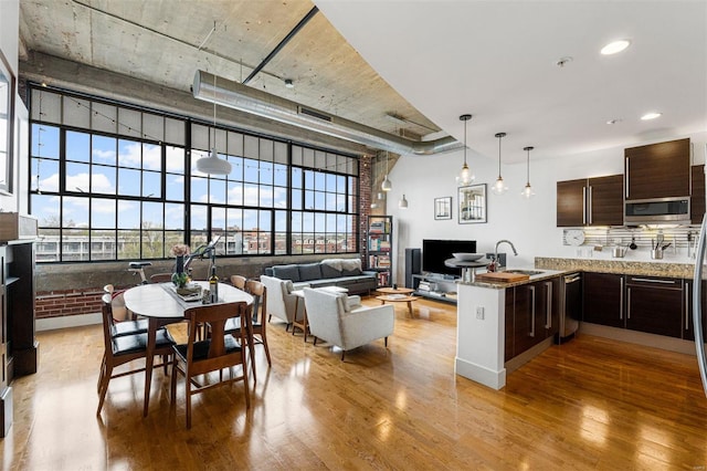 interior space featuring recessed lighting, a high ceiling, and wood finished floors
