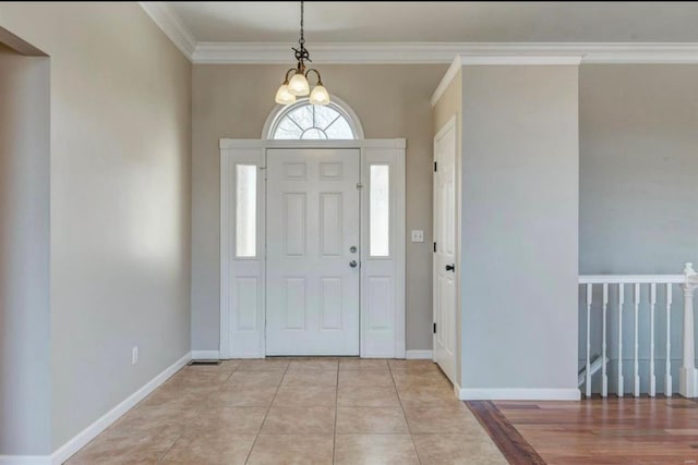 foyer featuring baseboards and ornamental molding
