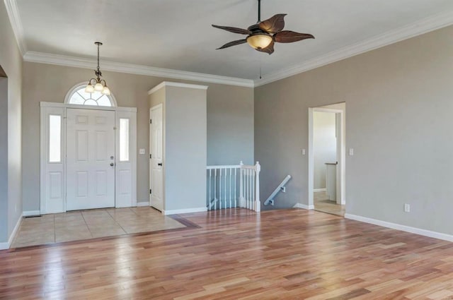 entryway with crown molding, light wood finished floors, baseboards, and ceiling fan