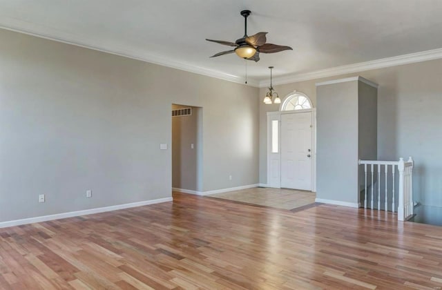 unfurnished room featuring light wood-style flooring, baseboards, visible vents, ceiling fan with notable chandelier, and crown molding