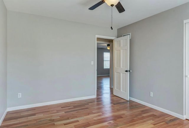 unfurnished room with light wood-type flooring, baseboards, and ceiling fan