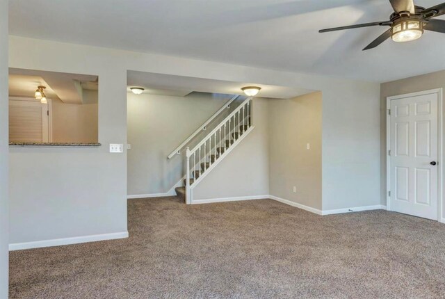 unfurnished living room featuring stairway, ceiling fan, baseboards, and carpet flooring