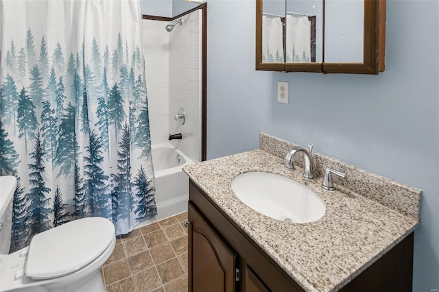 bathroom with shower / tub combo, toilet, stone finish floor, and vanity