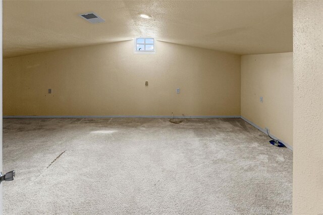 interior space with visible vents, carpet, and baseboards
