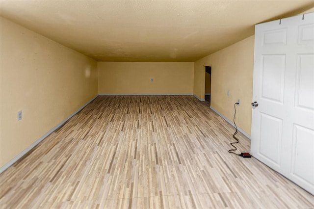unfurnished room featuring light wood finished floors and baseboards
