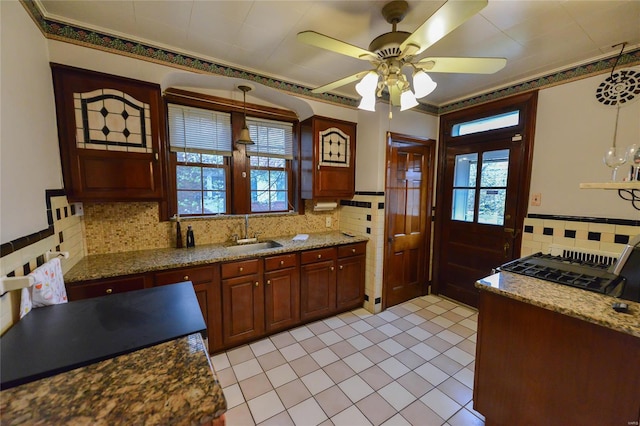 kitchen featuring a sink, decorative backsplash, plenty of natural light, and ceiling fan
