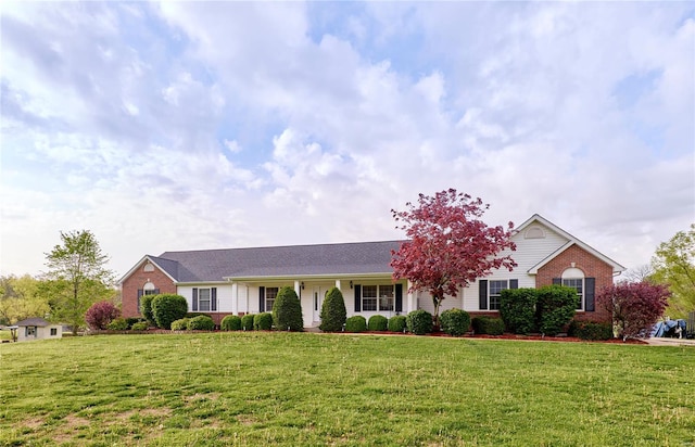 ranch-style house featuring a front lawn and brick siding