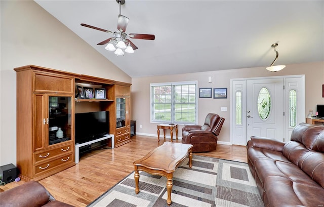 living area with a ceiling fan, light wood finished floors, high vaulted ceiling, and baseboards