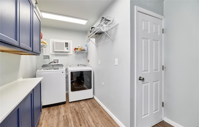 clothes washing area with cabinet space, baseboards, independent washer and dryer, and light wood-type flooring