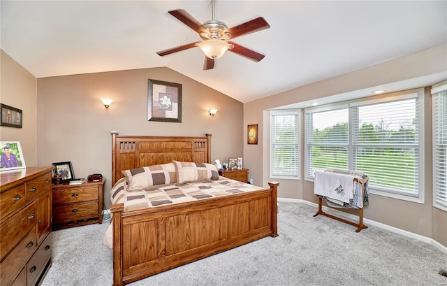 bedroom with baseboards, ceiling fan, light carpet, and lofted ceiling