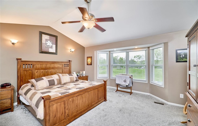 bedroom featuring ceiling fan, visible vents, vaulted ceiling, baseboards, and light colored carpet
