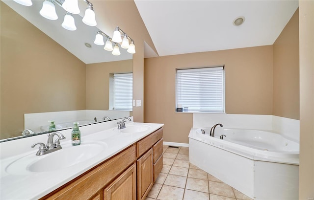 bathroom featuring a bath, tile patterned flooring, a sink, and vaulted ceiling