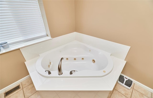 bathroom with visible vents, a whirlpool tub, tile patterned flooring, and baseboards