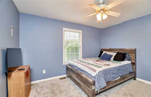 bedroom with a ceiling fan, carpet, and baseboards