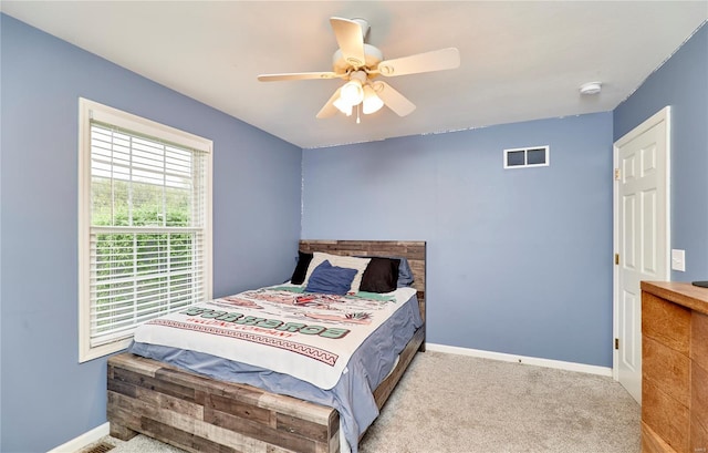 bedroom with baseboards, visible vents, ceiling fan, and carpet floors