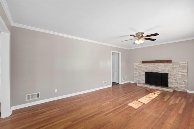 unfurnished living room featuring baseboards, visible vents, a ceiling fan, wood finished floors, and ornamental molding