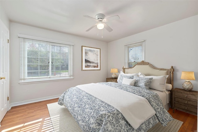 bedroom with wood finished floors, baseboards, and ceiling fan