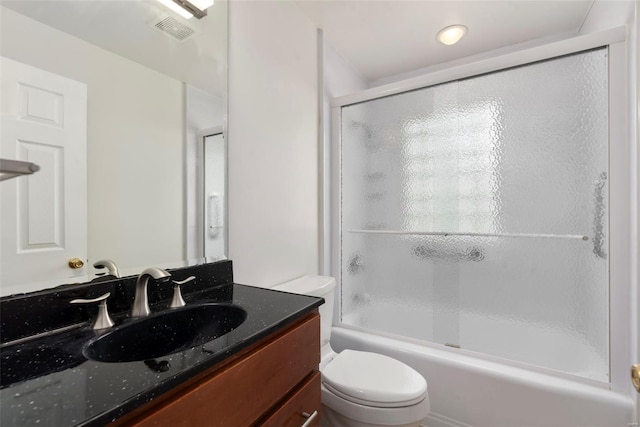 full bathroom featuring combined bath / shower with glass door, visible vents, toilet, and vanity