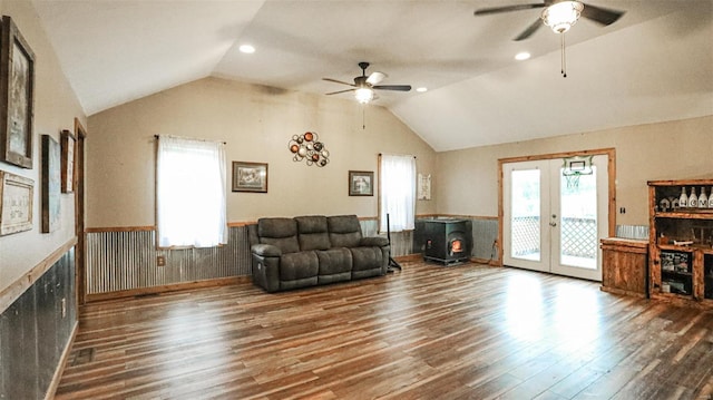 living area featuring vaulted ceiling, a ceiling fan, and wood finished floors