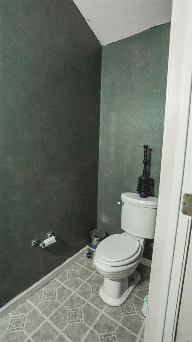 bathroom with tile patterned floors, toilet, and baseboards