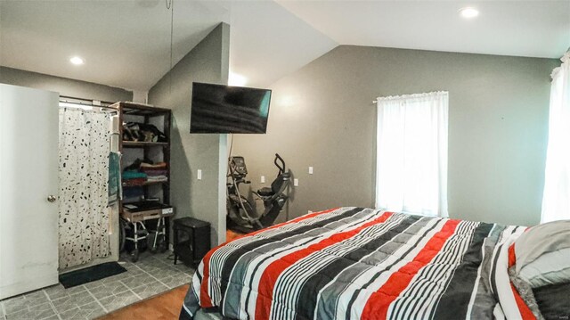 bedroom with recessed lighting, wood finished floors, and vaulted ceiling